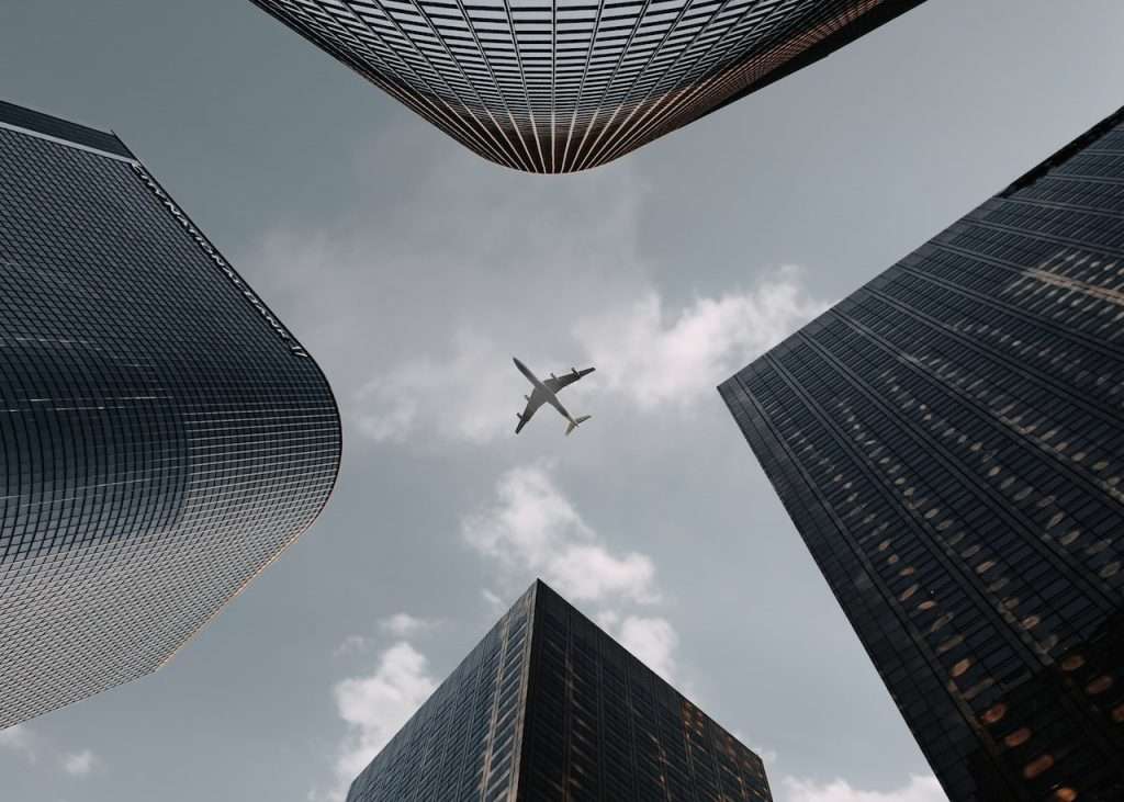 plane surrounded by buildings